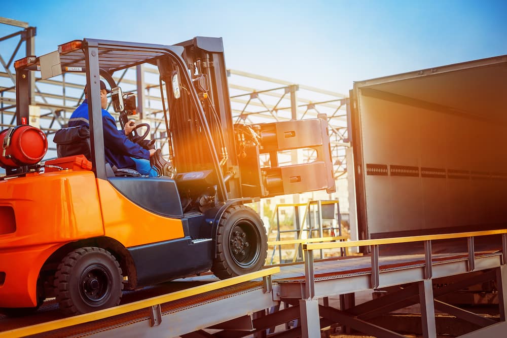 Man loading a truck with a forklift